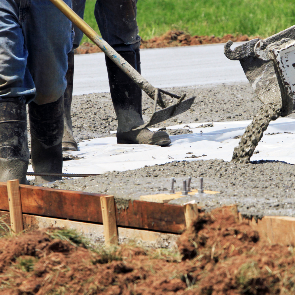 Men pouring a concrete storage pad for a business in Longmont, CO. 